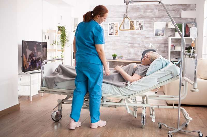 Mujer acostada en tipo de cama articulada hospitalaria